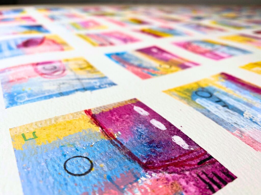 Close-up of several neighbouring painted squares with marks and colour continuing across their shared boundaries.