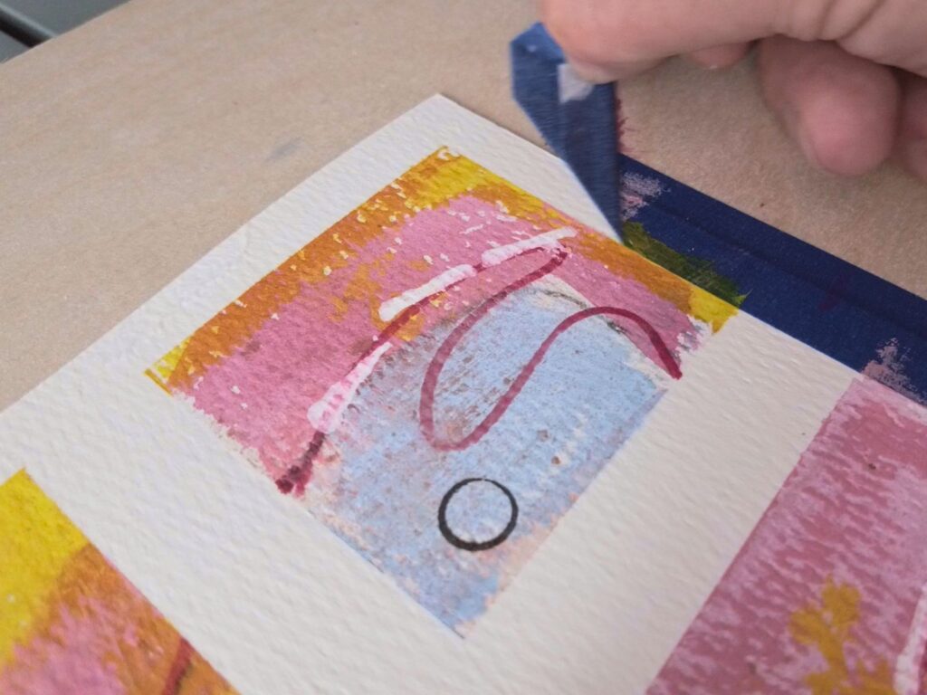 Tape being removed from the finished painted grid to reveal clean divisions between the 72 sections.