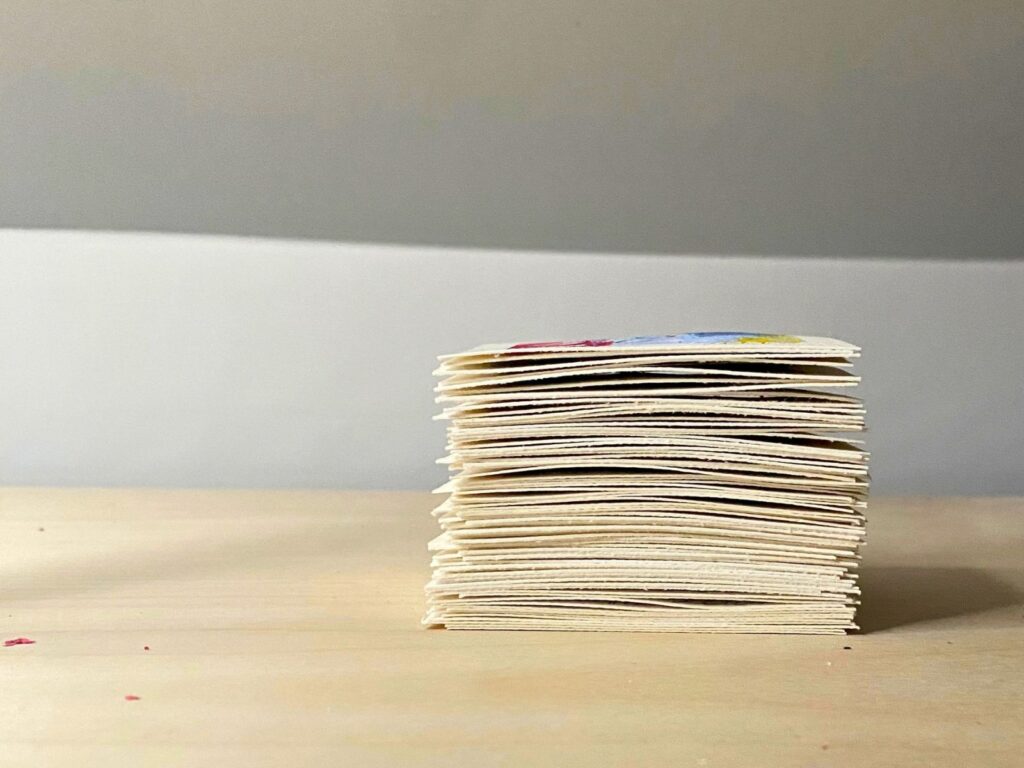 A group of finished 3-inch original artwork squares after the larger painting had been cut apart.